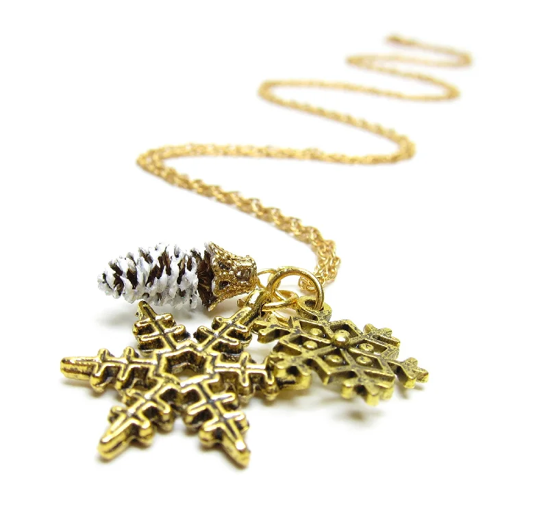 Elegant Sapphire Necklace For Special Events-Gold Pine Cone Necklace with Snowflake Charms and Real Pinecone